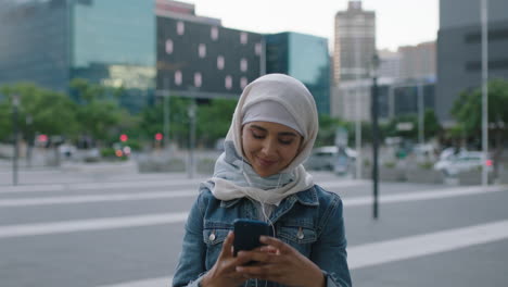 portrait of young modern muslim woman taking photo of city building using smarphone camera technology enjoying urban evening sightseeing travel