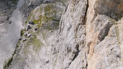 ascend top down shot along rocky wall of mountain in sunlight - brenta, dolomites