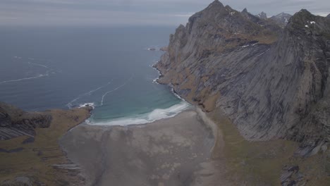 Aerial-view-of-the-Bunes-beach,-dark,-autumn-day-in-Lofoten,-Norway---pan,-drone-shot