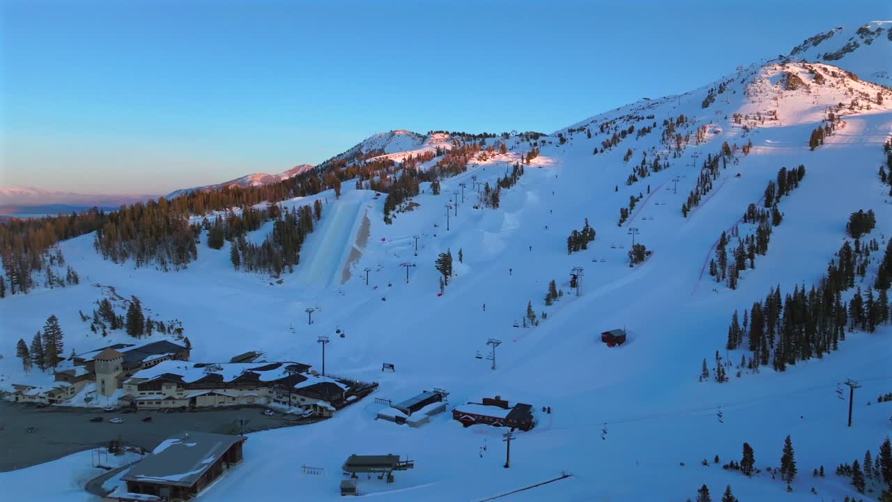 Sunset blue hour Main Lodge Mammoth Mountain ski resort spring winter California aerial drone Unbound Terrain Parks panorama landscape ski snowboard groomed trail runs chairlift gondola circle left