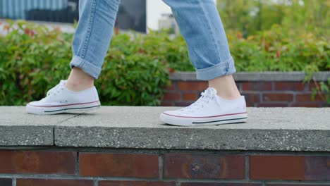 close up of girl’s legs walking in the city