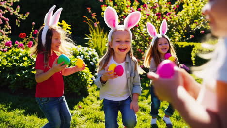 children enjoying an easter egg hunt in the garden