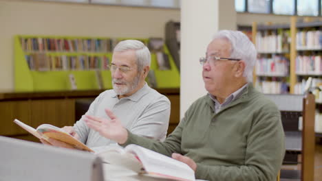 mature men talking while having lesson in library