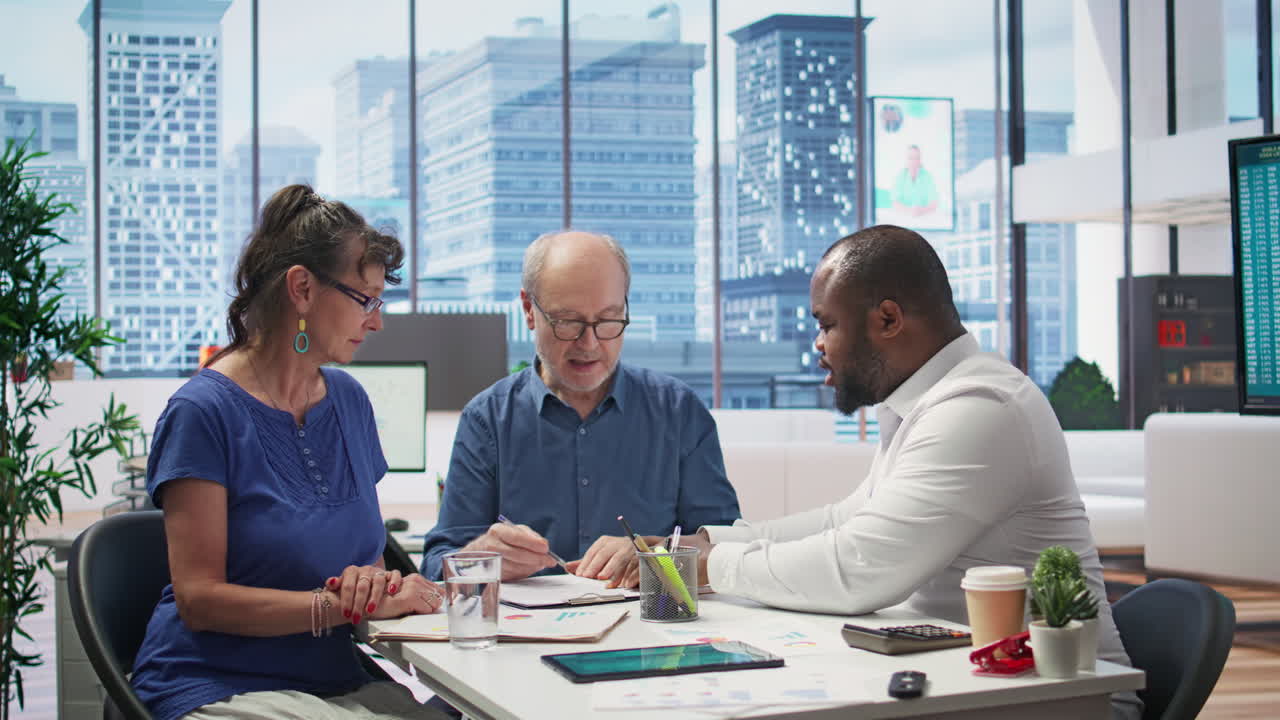 Senior people reading retirement plan contract terms with broker