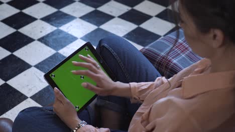 woman using tablet with green screen