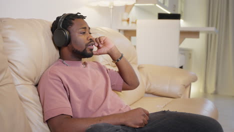 man listening to music on a couch