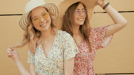 two friends posing in summer outfits