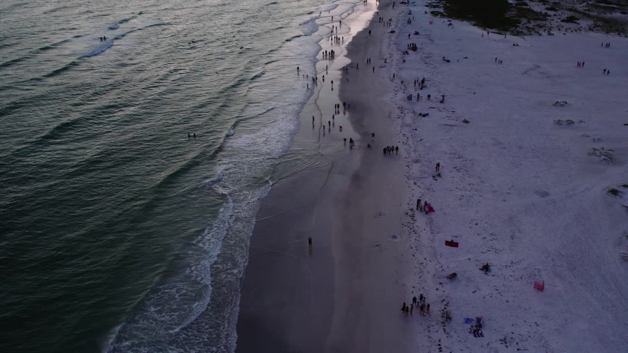Beautiful Florida sunset in Sarasota. Backward moving shot of coastline. 60 fps
