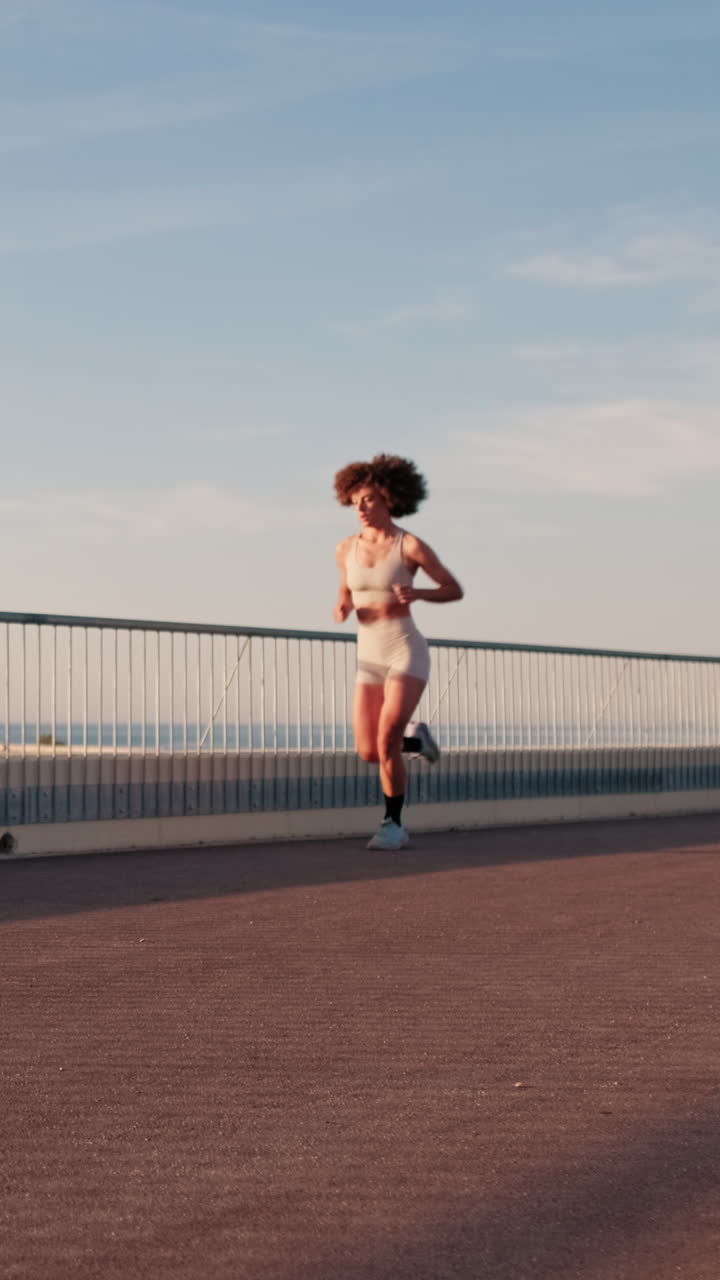 Young Woman Running By The Sea