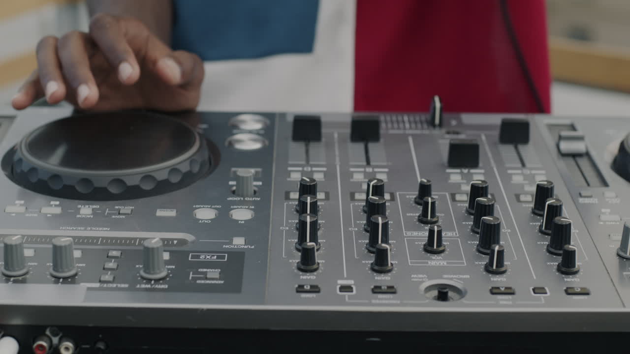 DJ Mixing Music on a Professional Mixer