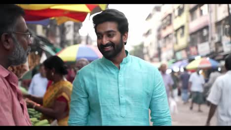 young man purchasing fresh produce from local street vendor, smiling while navigating crowded marketplace with vibrant atmosphere and bustling commerce
