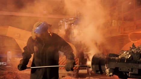 steel mill worker handling molten metal