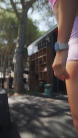 woman working out with a kettlebell at an outdoor gym