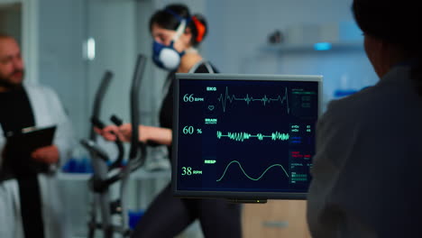 medical researcher examining ekg image showing on monitor