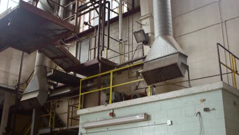 a tilt shot from a run-down control room to the ceiling in an abandoned factory