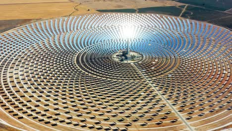 solar panels circular power plants with the reflection of the sunlight in the panels. renewable and pollution-free energy in a solar farm in spain- close-up view with a drone - environmental concept