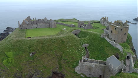 an aerial view of dunnottar castle on a misty and overcast day