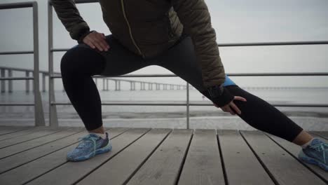 cropped shot of sportswoman warming up before workout