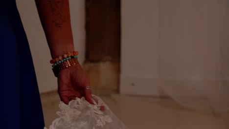 close-up of a woman holding a wedding dress veil