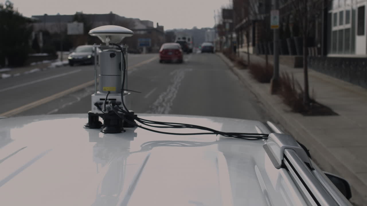 Street view vehicle map generation vehicle drives through city with a LIDAR scanning device on its roof