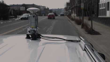 street view vehicle map generation vehicle drives through city with a lidar scanning device on its roof