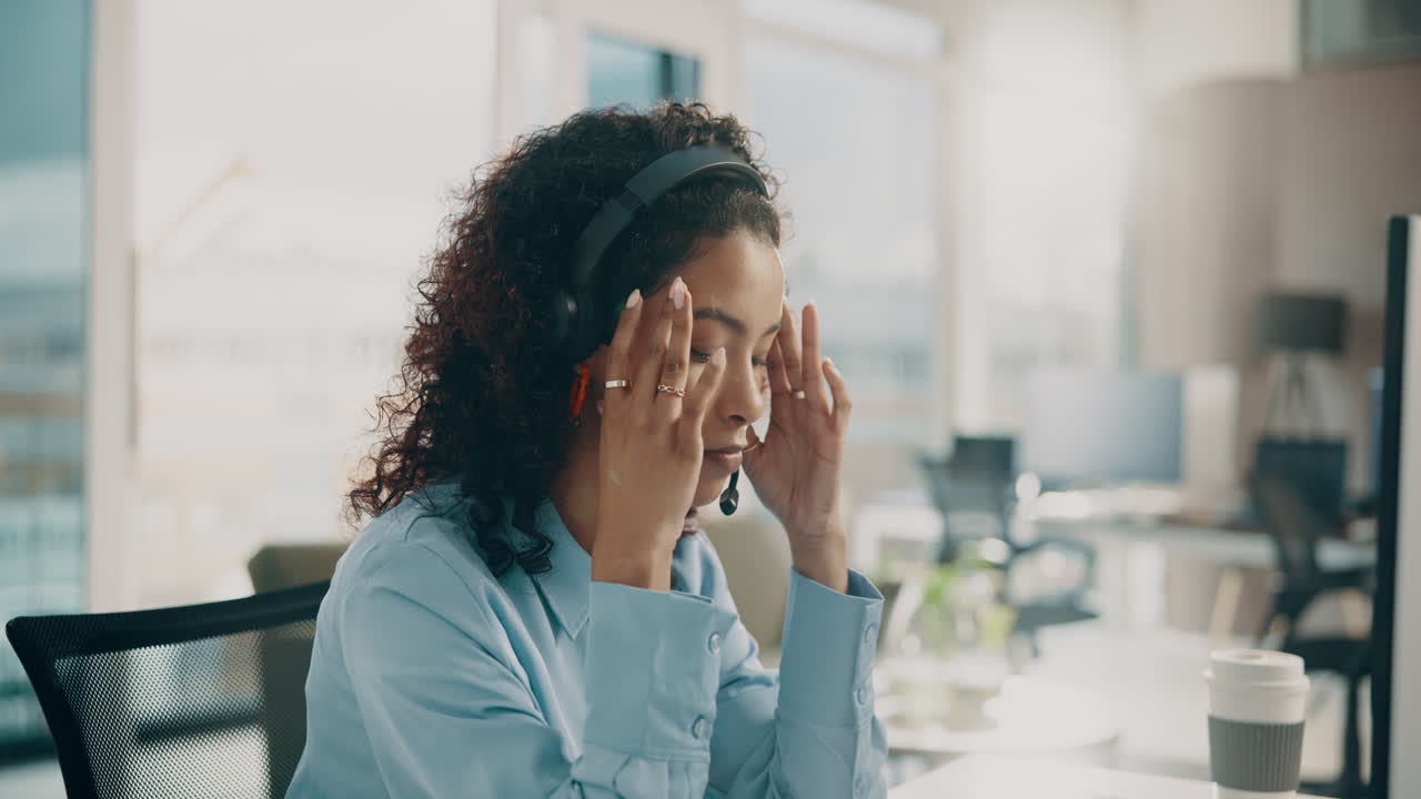 Stressed customer service worker with headset