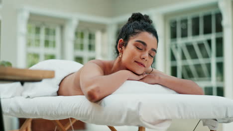 woman relaxing on massage table at spa