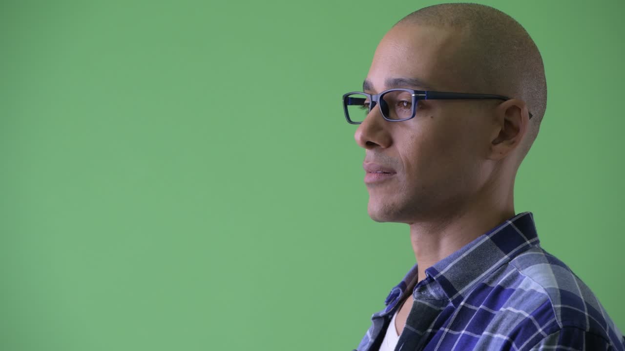 Happy handsome bald hipster man with eyeglasses