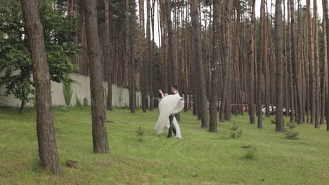 Lovely-newlyweds-caucasian-bride-groom-dancing-in-park,-making-kiss,-wedding-couple-family