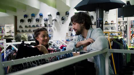 young couple enjoy and fun outdoor lifestyle shopping together, choosing pants