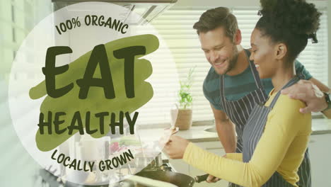 animation of eat healthy text over diverse couple preparing healthy meal in kitchen