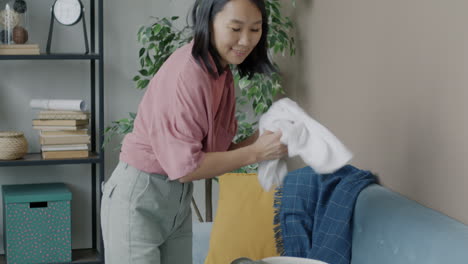 woman organizing laundry in living room