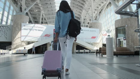 woman with luggage at a train station