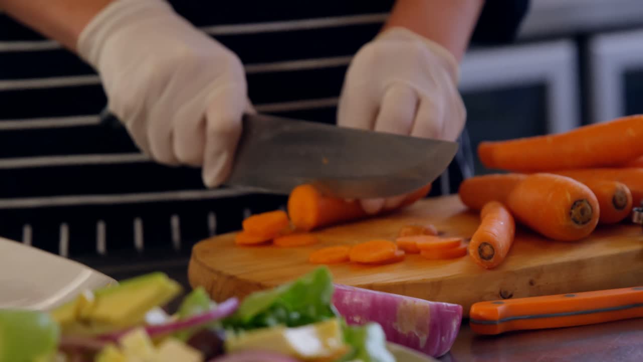 Chef chopping carrot in commercial kitchen 4k