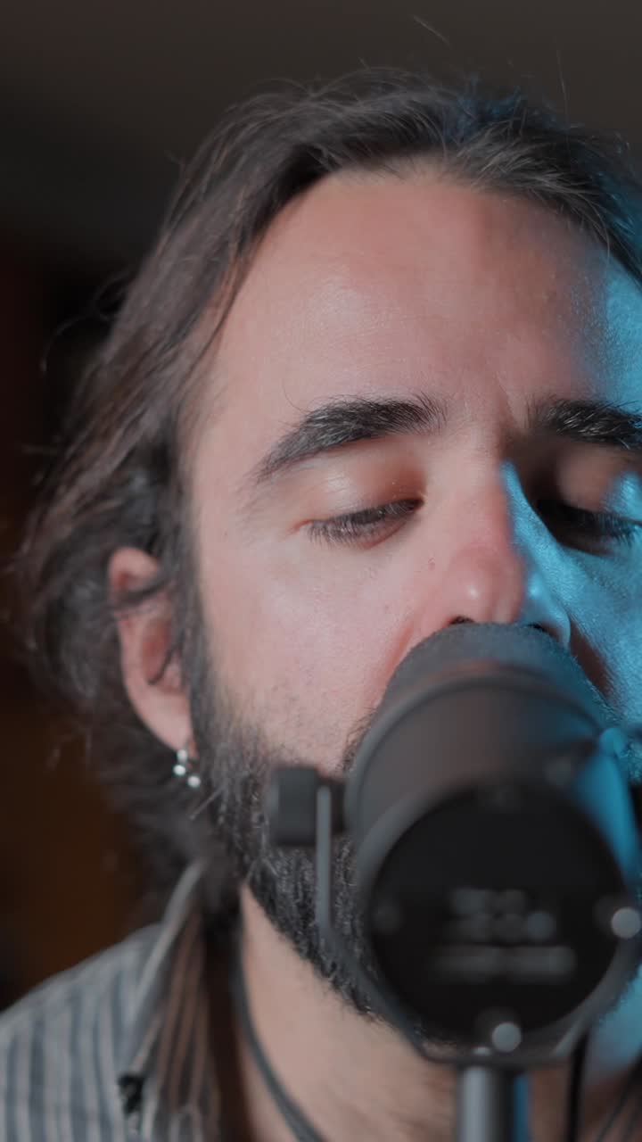 Man Singing into a Microphone with Eyes Closed