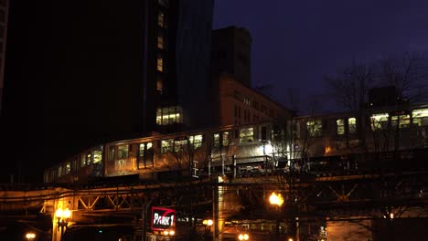 chicago subway train passing through city center at night