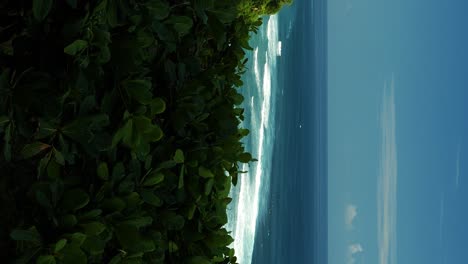 Vertical-Handheld-Shot-of-Suluban-Beach-Overlooking-the-Beautiful-Cliffs-and-the-Blue-Sea-on-a-Sunny-Summer-Day-in-Bali,-Indonesia