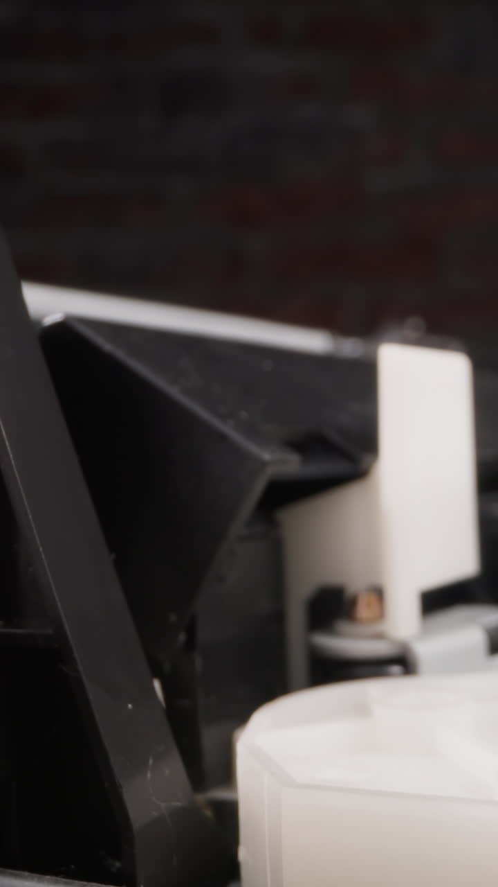 Video recorder puts tape in cassette and reads information with head in room macro view. Vintage tool to enjoy movie at home. Electric videocassette appliance