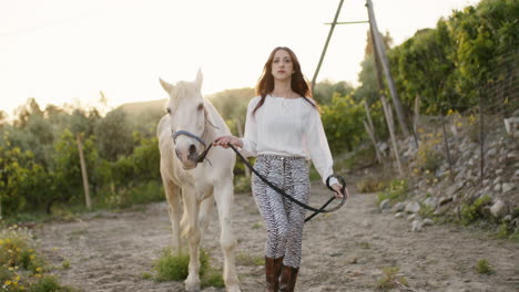 model walking with a white horse