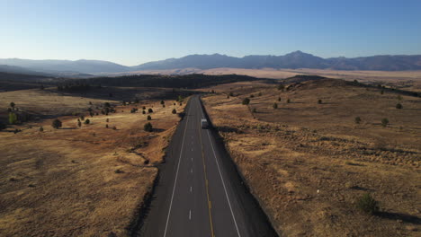 A-semi-truck-and-trailer-on-the-open-road-outside-of-Prairie-City,-Oregon