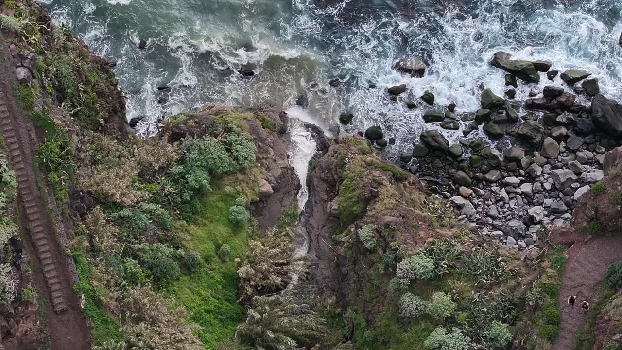 Majestic waterfall flows directly into the ocean