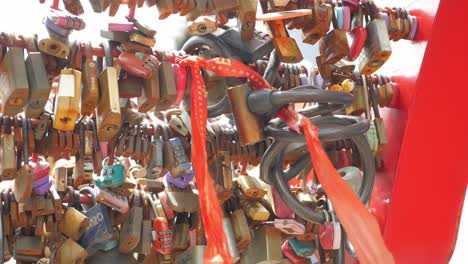 many love padlocks locked on rusty iron gate in singapore ,