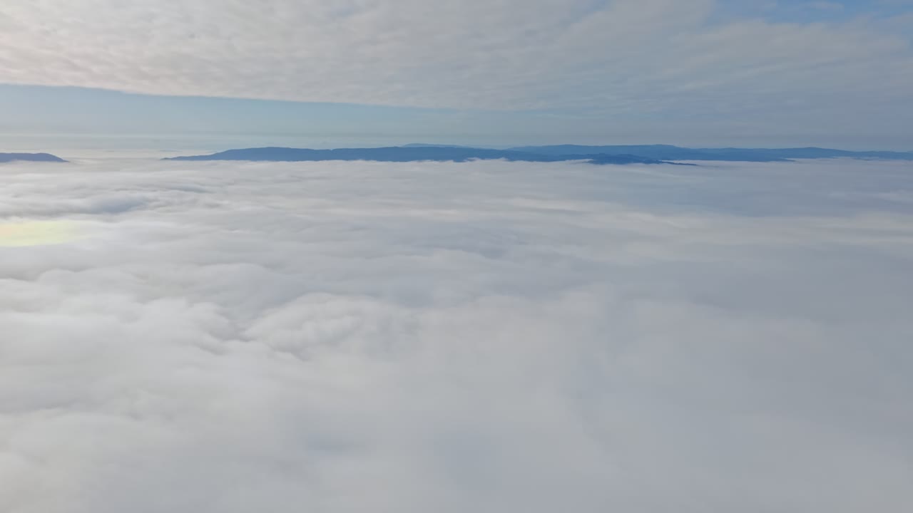 Aerial View Above Clouds and Fog with Andes Mountain Cordillera Horizon Chile