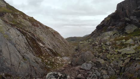 Rocky-Norwegian-gorge,-aerial-flight-through-canyon