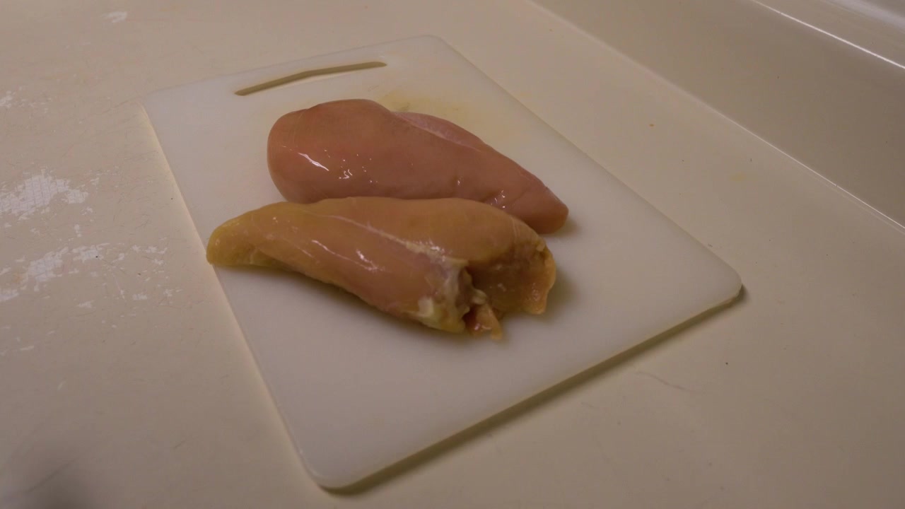 Raw chicken placed on the cutting board ready to be seasoned then BBQ'd