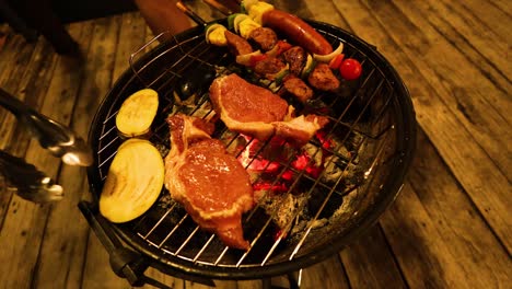 grilling meat and vegetables on a charcoal barbecue