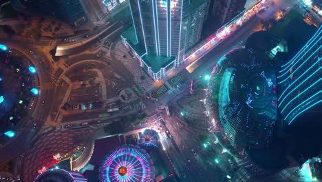 night illumination macau city bay downtown hotel traffic circle aerial topdown panorama 4k china