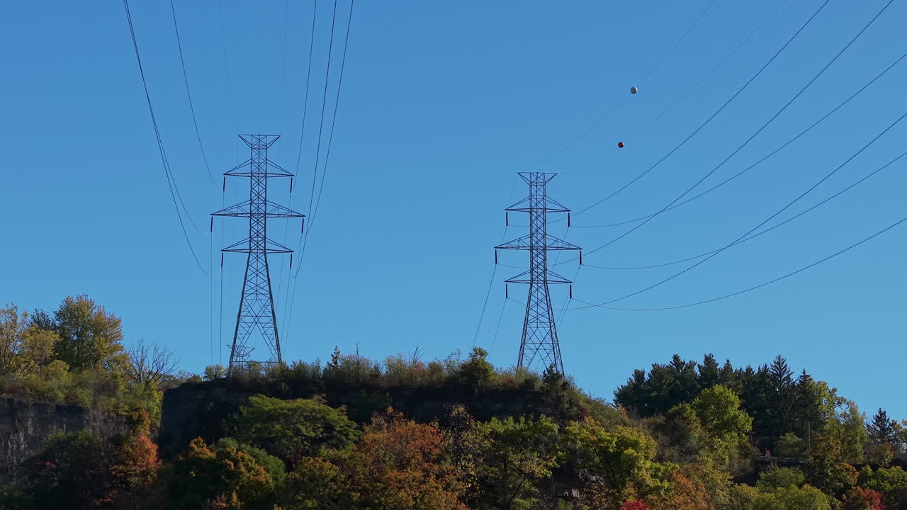 High voltage power towers above Niagara River gorge in autumn landscape