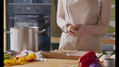 woman peeling potatoes in a kitchen