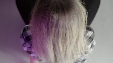 woman seated in studio with purple lighting